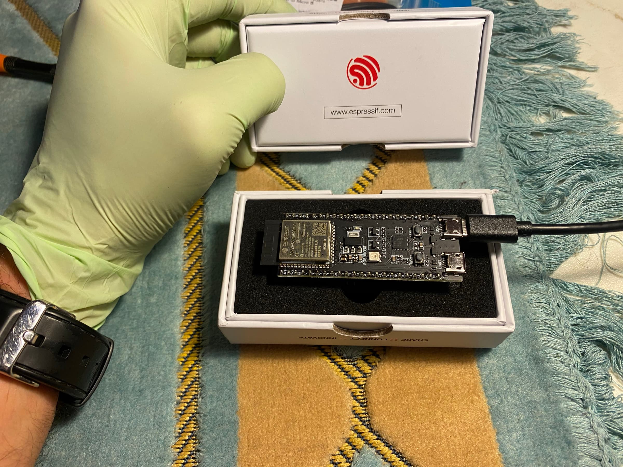 Mathew handling ESP32 development hardware connected by USB